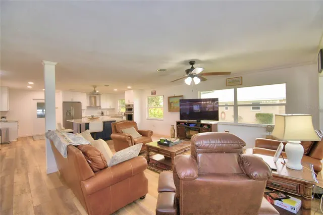 a living room with furniture a fireplace and a large window