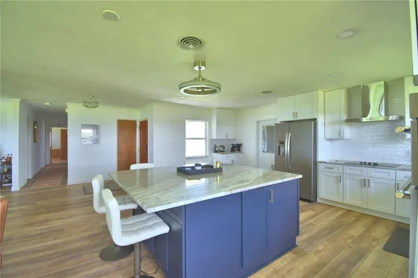 a kitchen with sink refrigerator and dining table