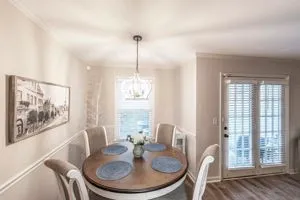 a dining room with furniture a window and wooden floor
