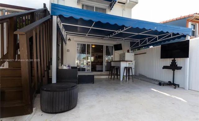 a view of living room filled with furniture and a refrigerator