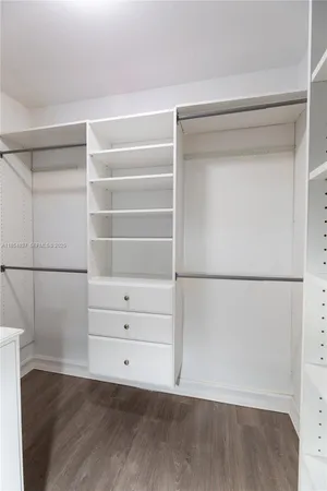 a view of walk in closet with empty racks