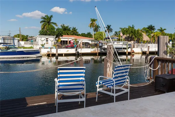 a outdoor patio with swimming pool table and chairs