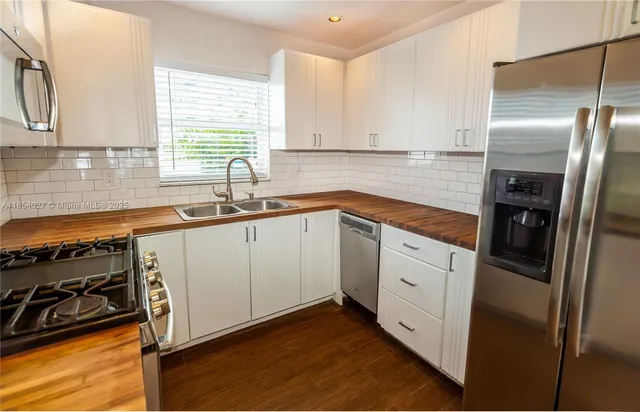 a kitchen with a sink stove and refrigerator