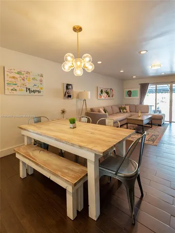a view of a dining room with furniture wooden floor and chandelier
