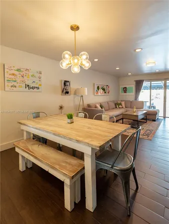 a view of a dining room with furniture wooden floor and chandelier