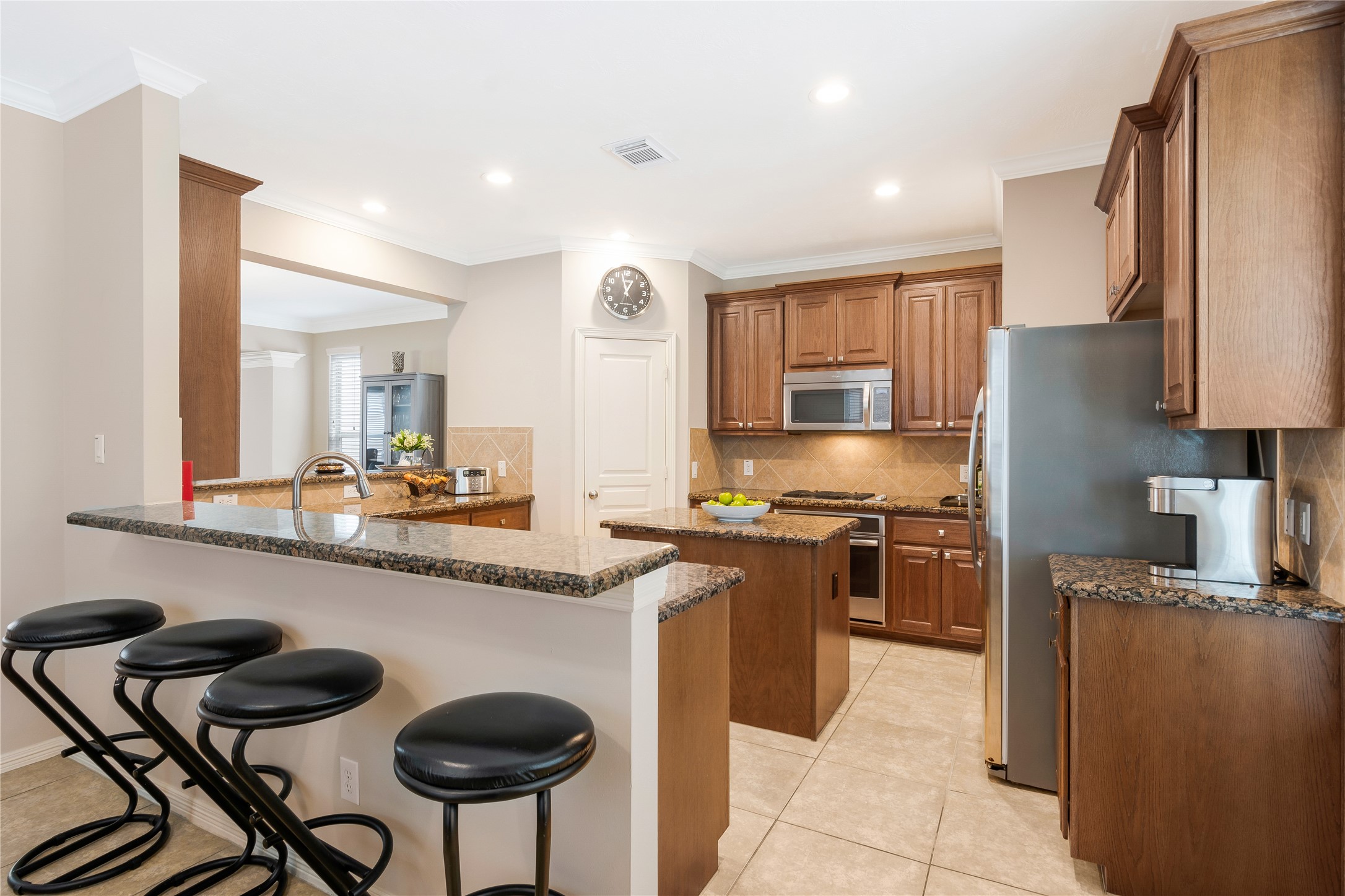 1241 Prince Street Houston, TX 77008 - Photo 23 of 45 a kitchen with stainless steel appliances granite countertop a stove a sink a refrigerator and chairs