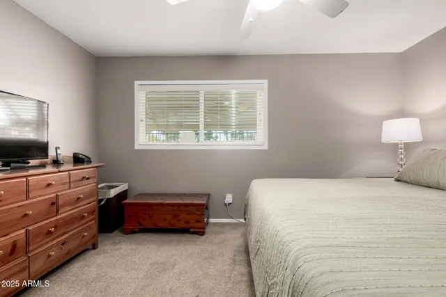 a bedroom with a bed and flat screen tv