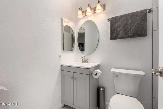 a bathroom with a toilet sink and mirror