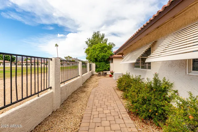 a view of a balcony with wooden floor and fence