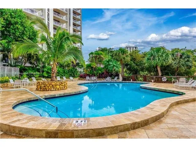 a view of a swimming pool with an outdoor space and seating area