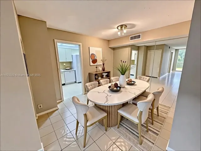 a view of a dining room with furniture and window
