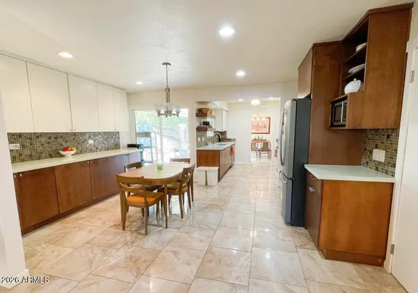 a large kitchen with kitchen island a sink a counter space and stainless steel appliances