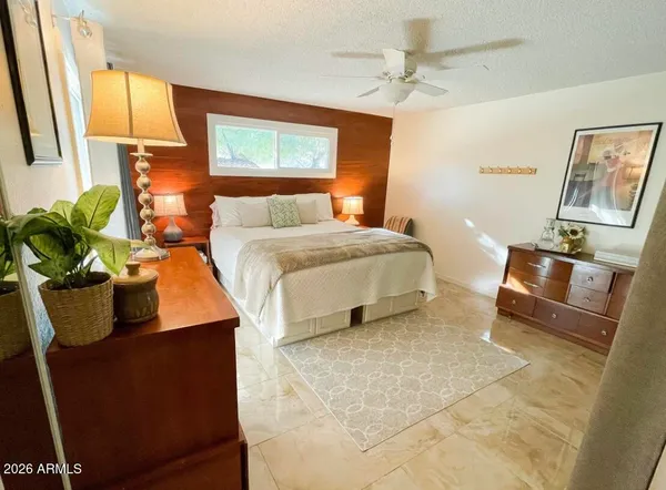 a bedroom with a bed mirror and window