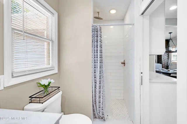 a bathroom with a toilet a sink and a window