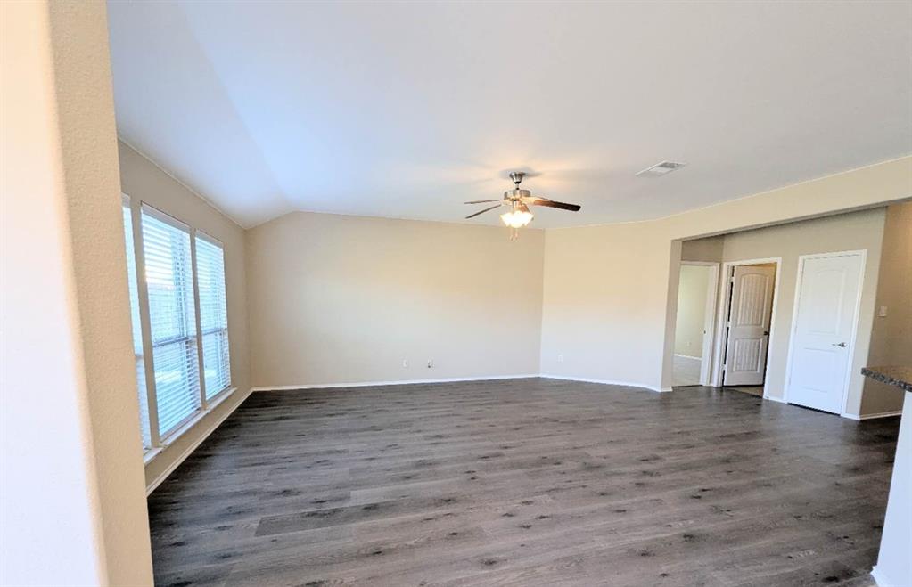 2110 Spruce Street Anna, TX 75409 - Photo 3 of 13 a view of an empty room with wooden floor and a window