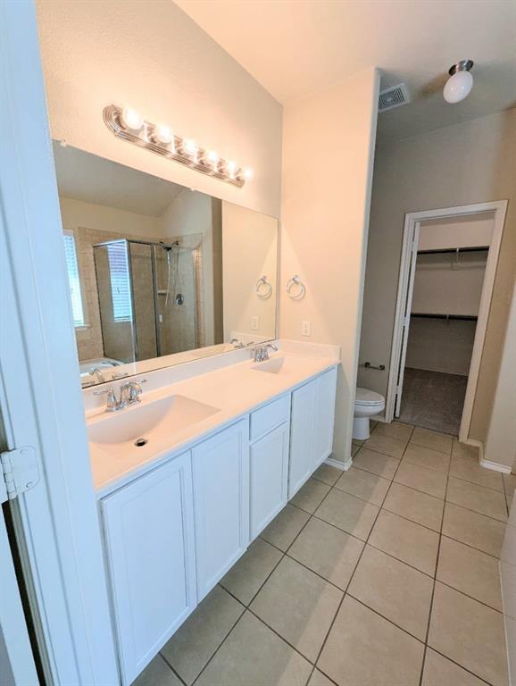 2110 Spruce Street Anna, TX 75409 - Photo 10 of 13 a spacious bathroom with a double vanity sink mirror and bathtub
