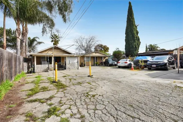 a car parked in front of white house