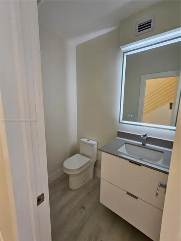 a kitchen with granite countertop a sink stainless steel appliances and cabinets