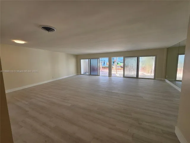 a kitchen with a refrigerator and cabinets