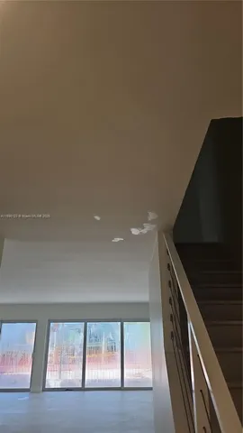 an aerial view of a house with a lake view