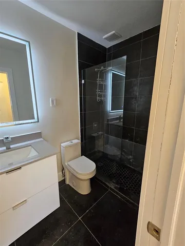 an empty room with closet and a bathroom