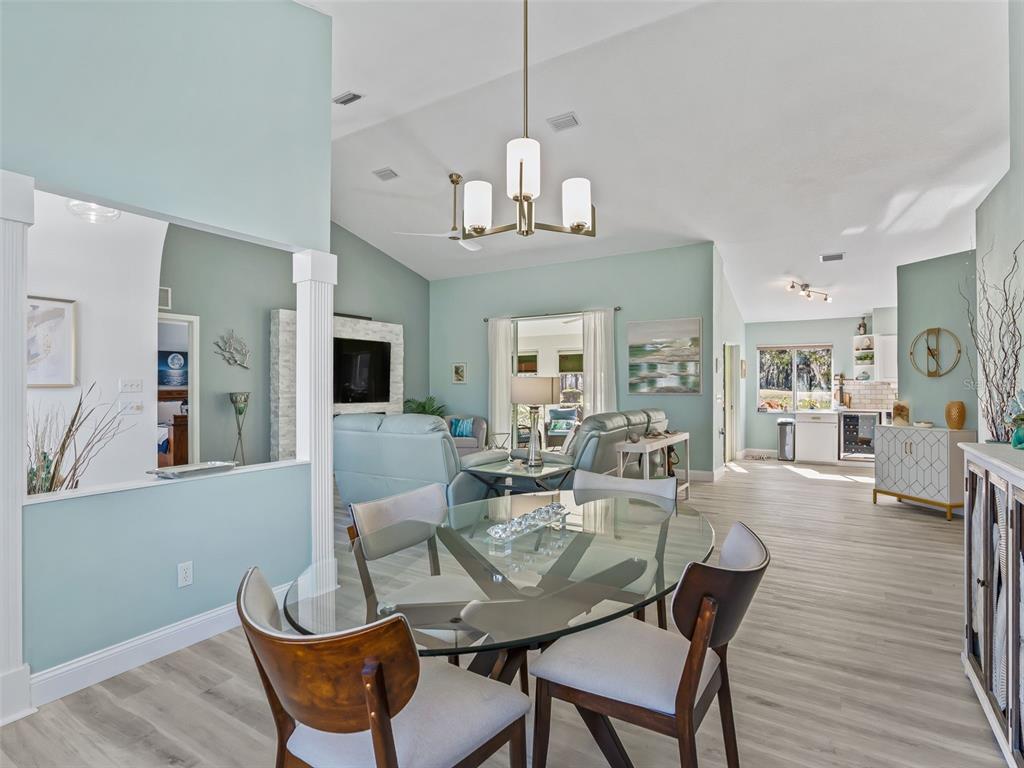 5016 Northwest 18th Street Ocala, FL 34482 - Photo 15 of 40 a view of a dining room with furniture wooden floor and chandelier