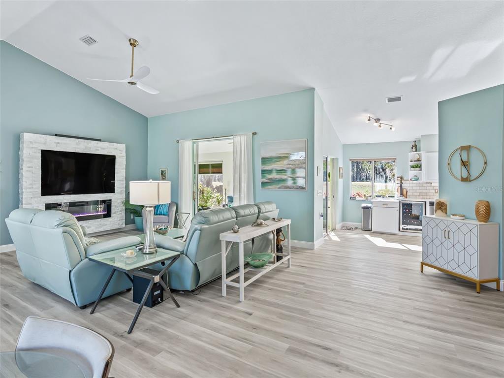 5016 Northwest 18th Street Ocala, FL 34482 - Photo 16 of 40 a living room with furniture a flat screen tv and kitchen view