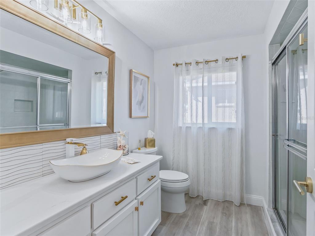 5016 Northwest 18th Street Ocala, FL 34482 - Photo 29 of 40 a bathroom with a granite countertop sink toilet and shower