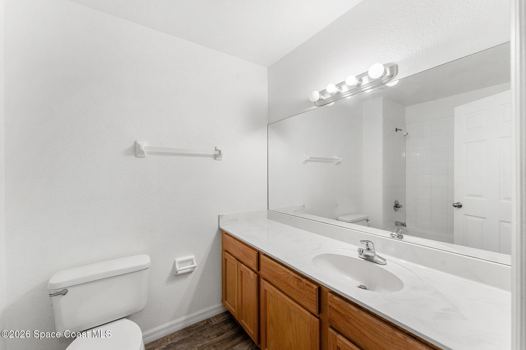 110 Turpial Way, Unit 102 Melbourne, FL 32901 - Photo 11 of 23 a bathroom with a toilet a sink and mirror