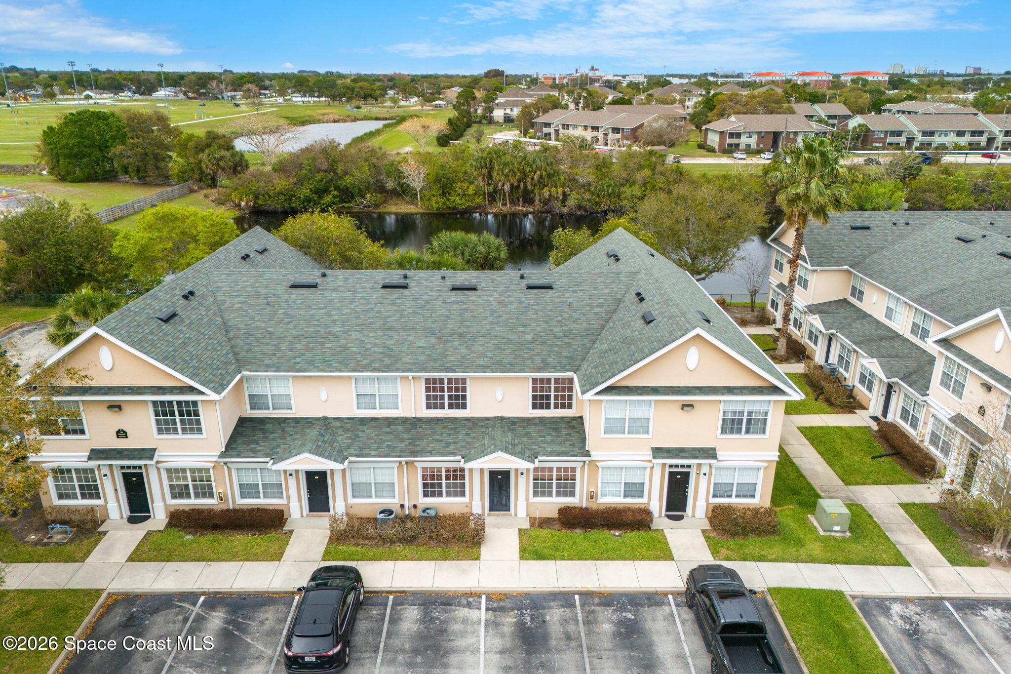 110 Turpial Way, Unit 102 Melbourne, FL 32901 - Photo 15 of 23 an aerial view of multiple houses with a swimming pool