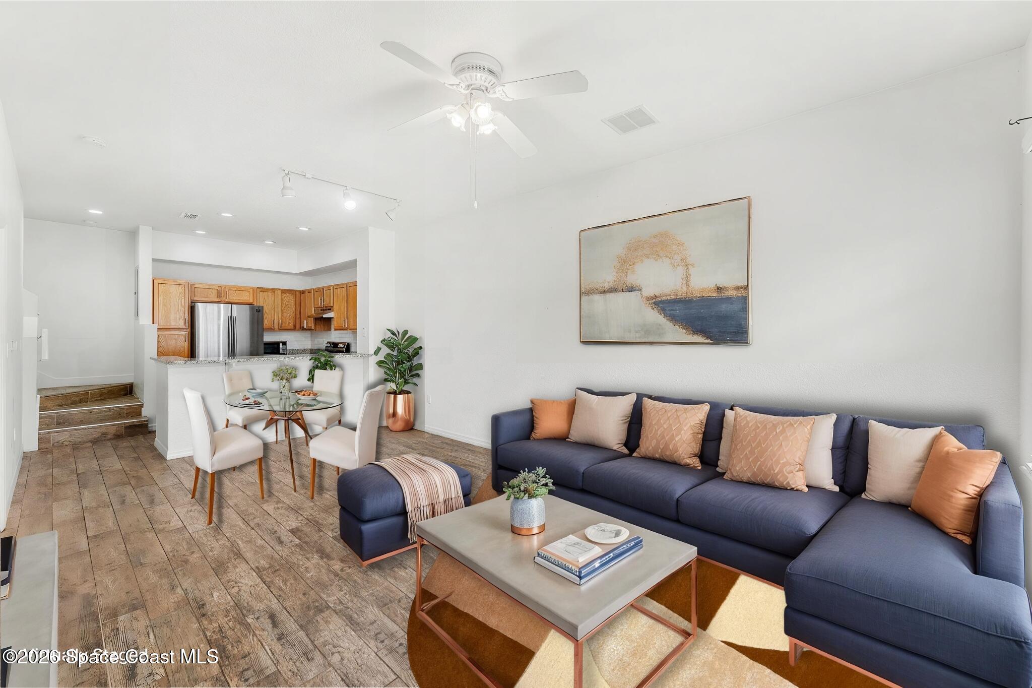 110 Turpial Way, Unit 102 Melbourne, FL 32901 - Photo 2 of 23 a living room with furniture kitchen view and a potted plant