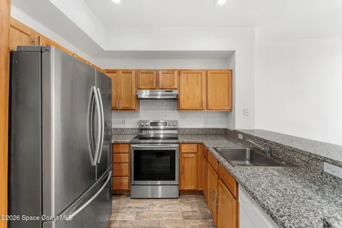 a kitchen with a refrigerator sink and stove