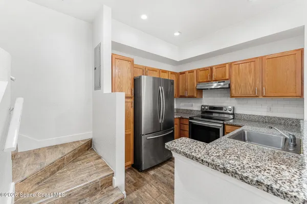 a kitchen with a refrigerator sink and cabinets