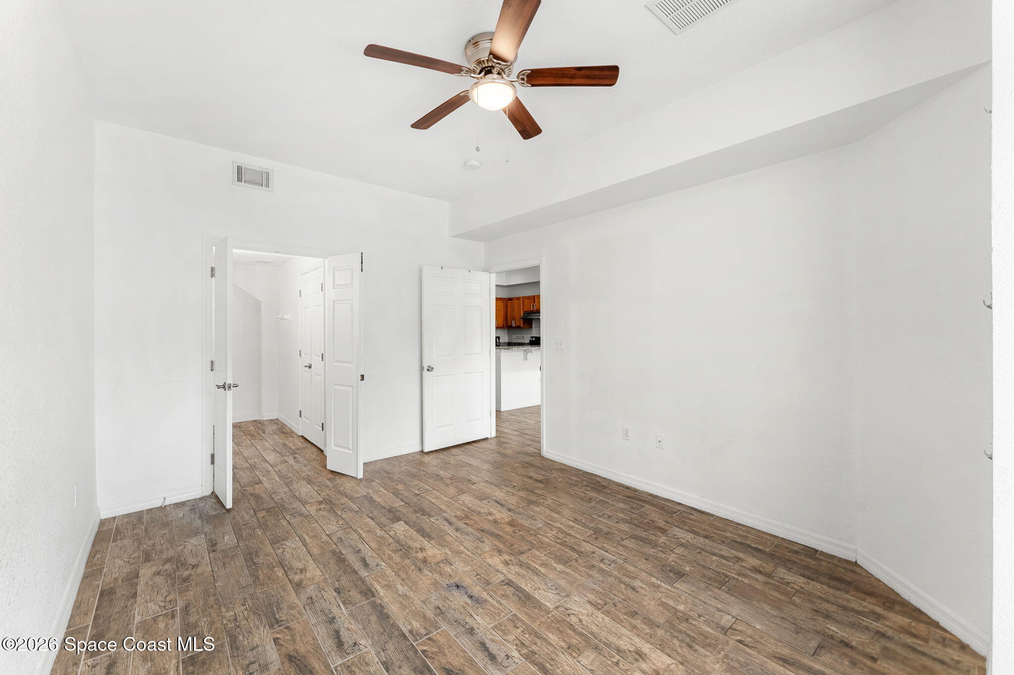 110 Turpial Way, Unit 102 Melbourne, FL 32901 - Photo 7 of 23 a view of empty room with wooden floor