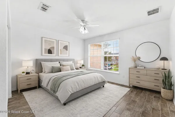 a bedroom with a bed and a dresser