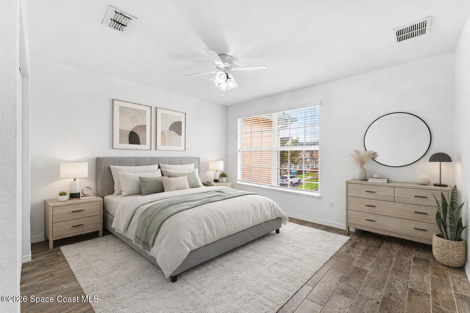 110 Turpial Way, Unit 102 Melbourne, FL 32901 - Photo 9 of 23 a bedroom with a bed and a dresser