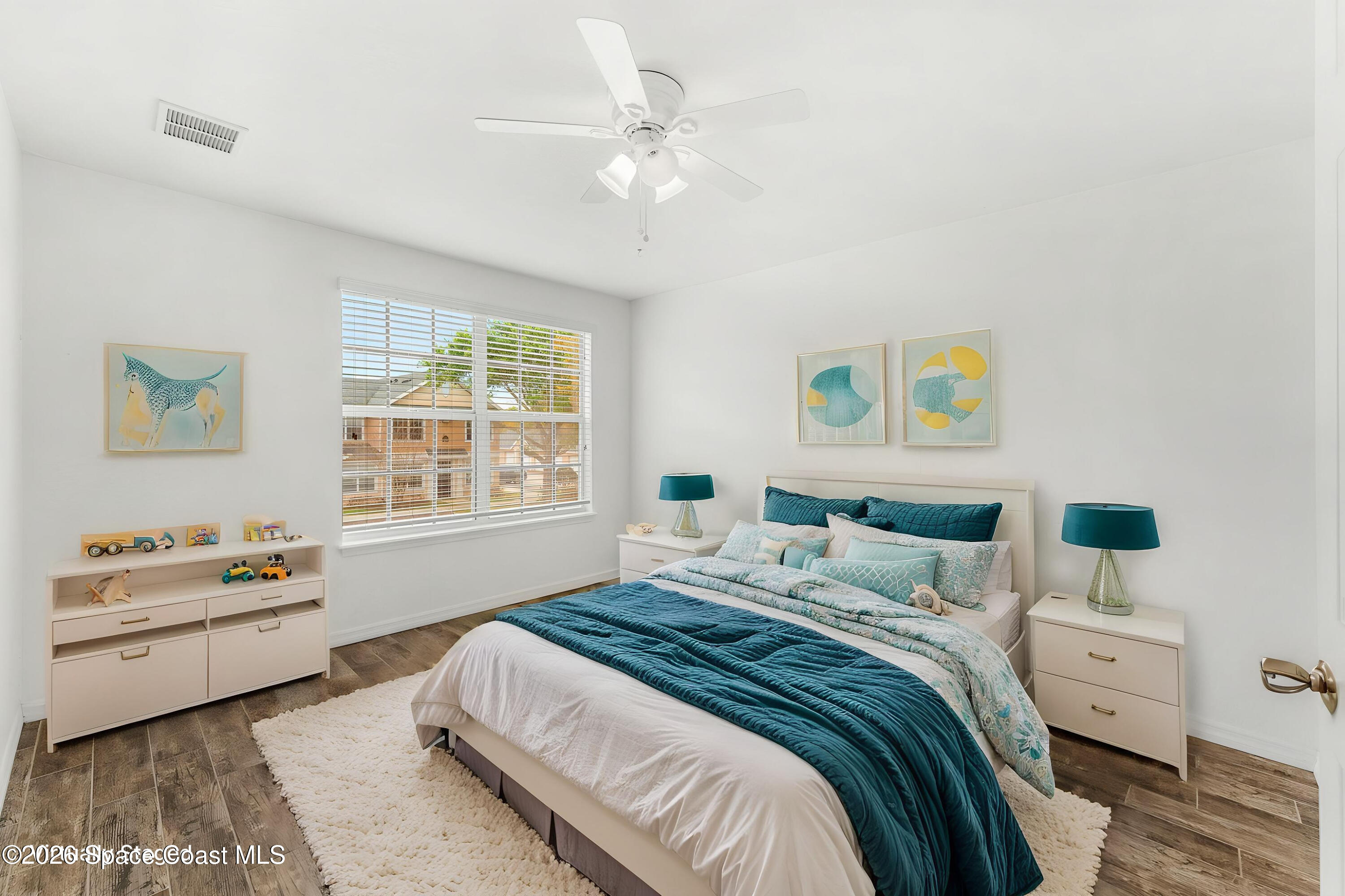 110 Turpial Way, Unit 102 Melbourne, FL 32901 - Photo 10 of 23 a bedroom with a bed and a window