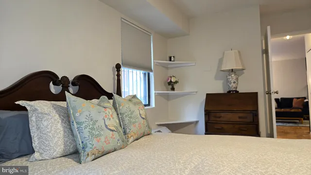 a bedroom with a bed and dresser