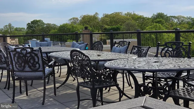 a view of a chairs and table on the roof deck
