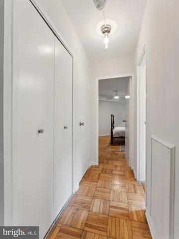 a view of a room with wooden floor and a bathroom