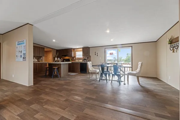 a view of a dining room kitchen with furniture and wooden floor
