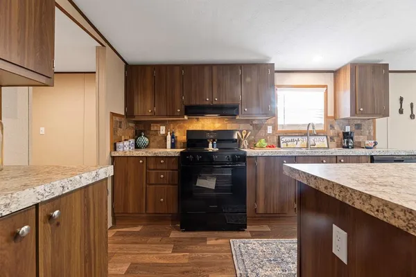 a kitchen with a stove a sink and a refrigerator