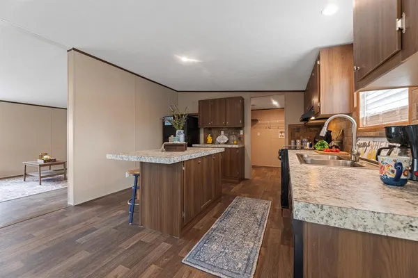 a kitchen with sink cabinets and wooden floor