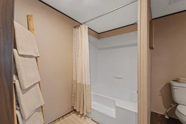 a bathroom with a glass shower door and a sink