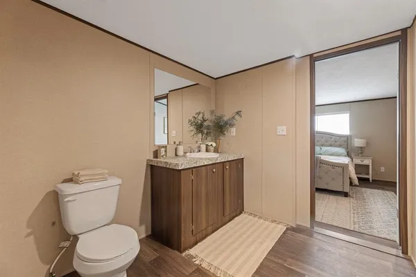 a bathroom with a toilet a sink and mirror