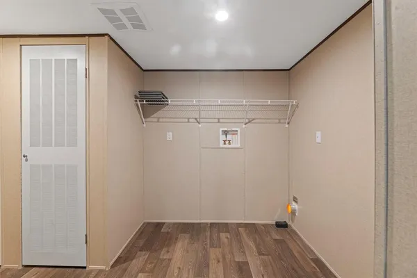 a view of a room with wooden floor