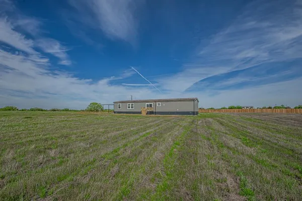 a view of a field with an ocean