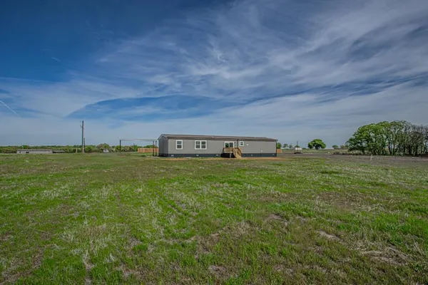 a view of a green field with clear sky