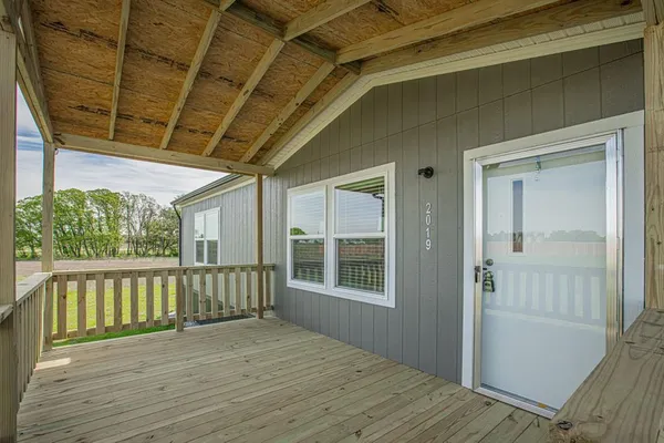 a view of a balcony with wooden floor