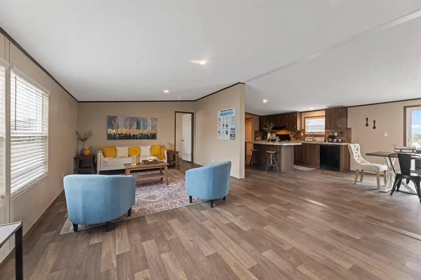 a living room with furniture and a wooden floor